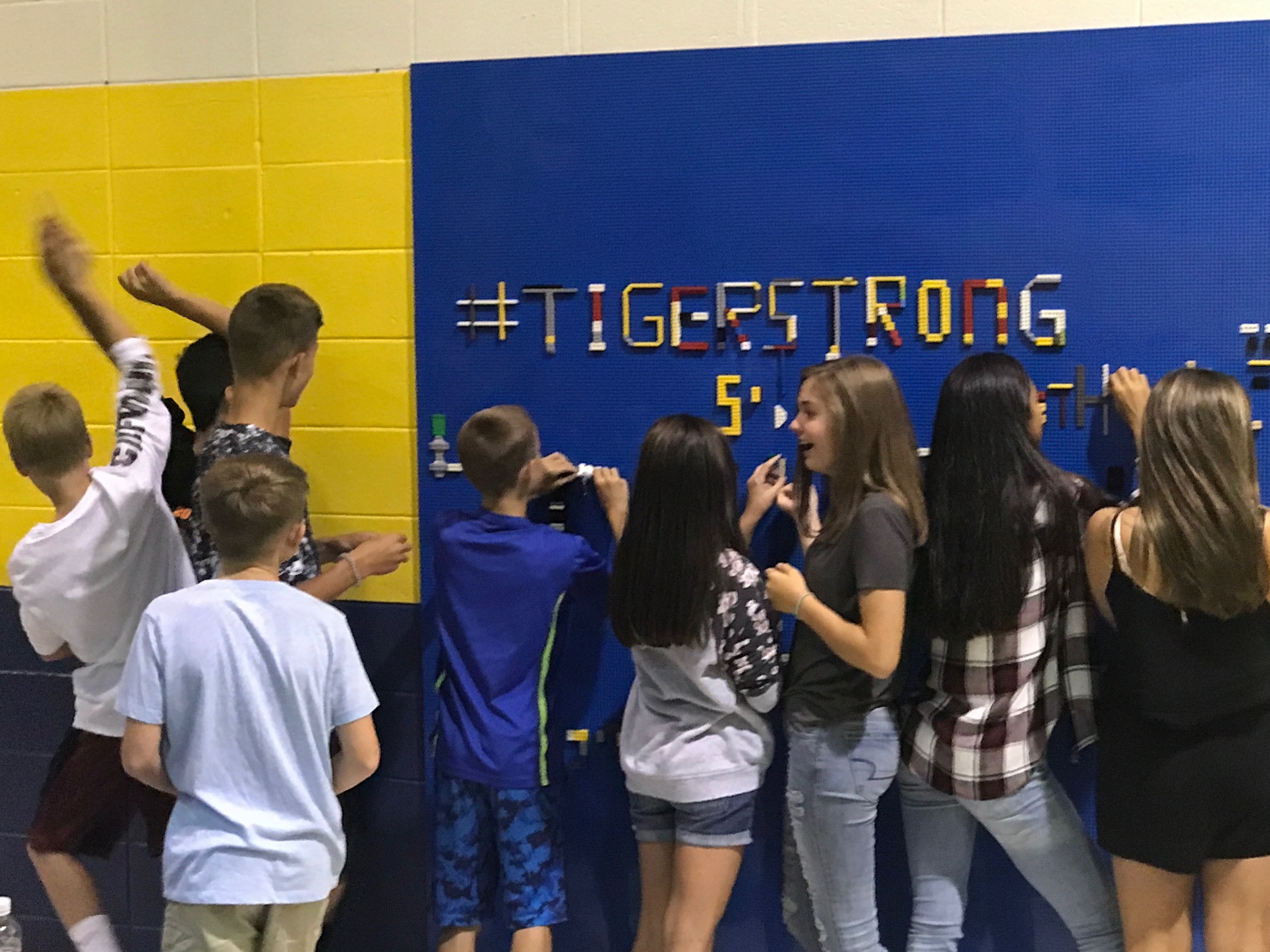 Students having fun with a lego wall.