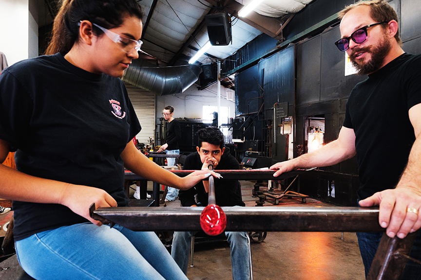 Students and teacher in glass-blowing class