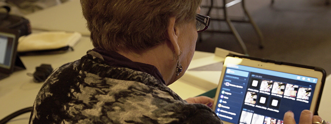 A woman continues her work on a tablet computer.