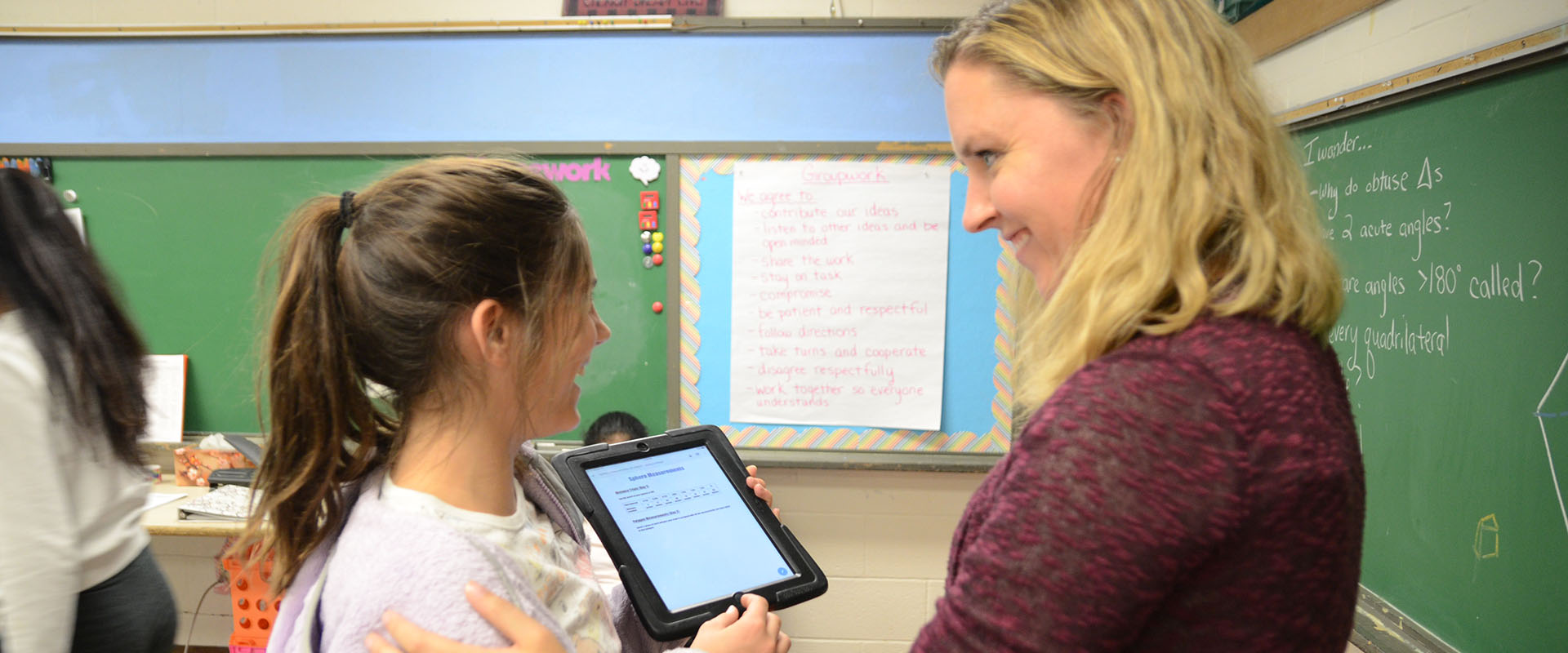 teacher and student looking at ipad