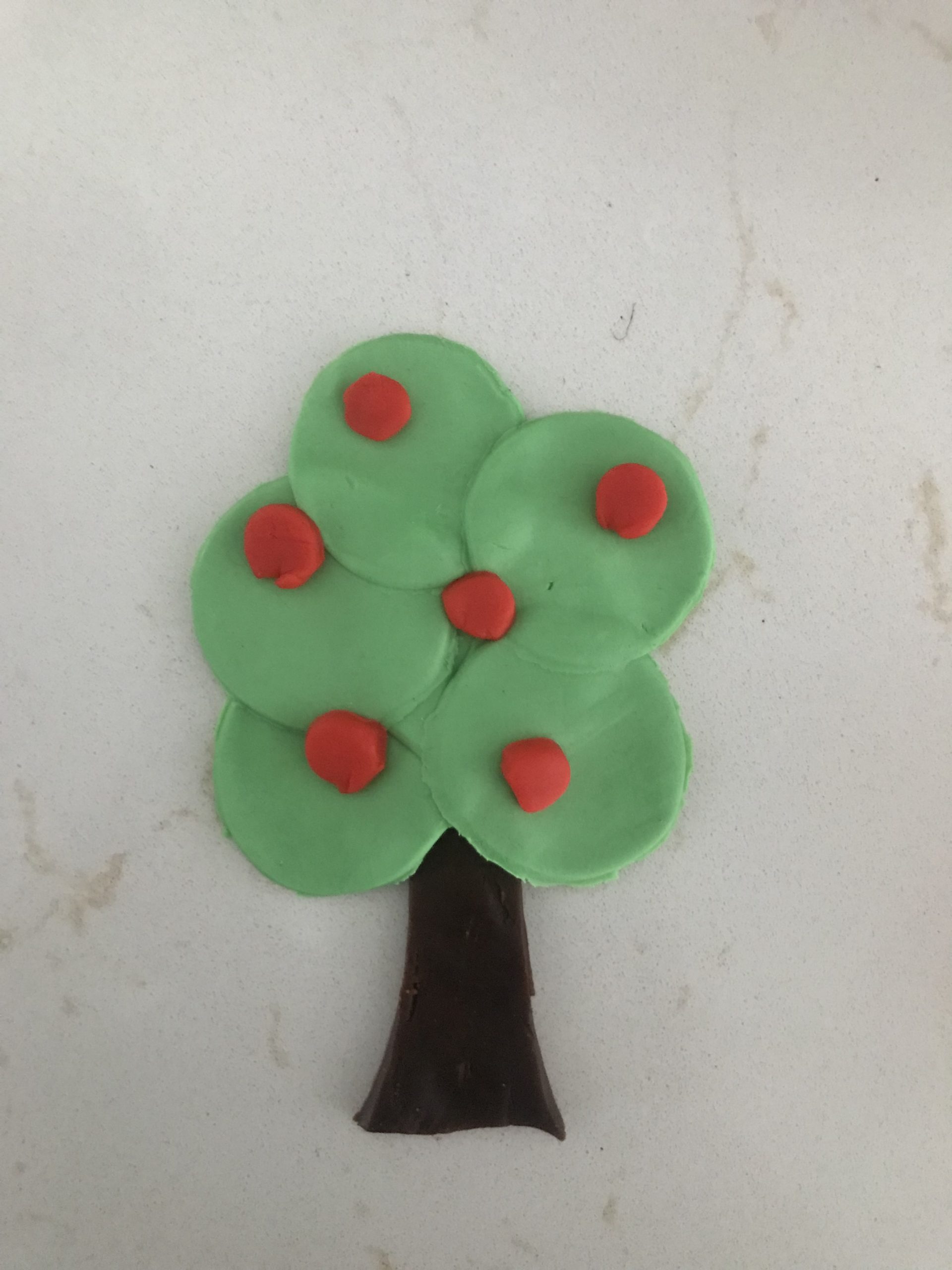 Tree created with green, red, and brown playdough