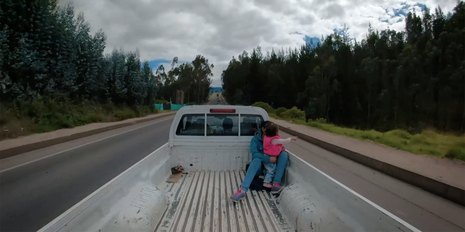 Woman and girl in back of a pickup truck