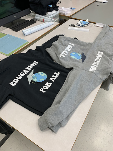 T-Shirts with "Education for All" printed on them.