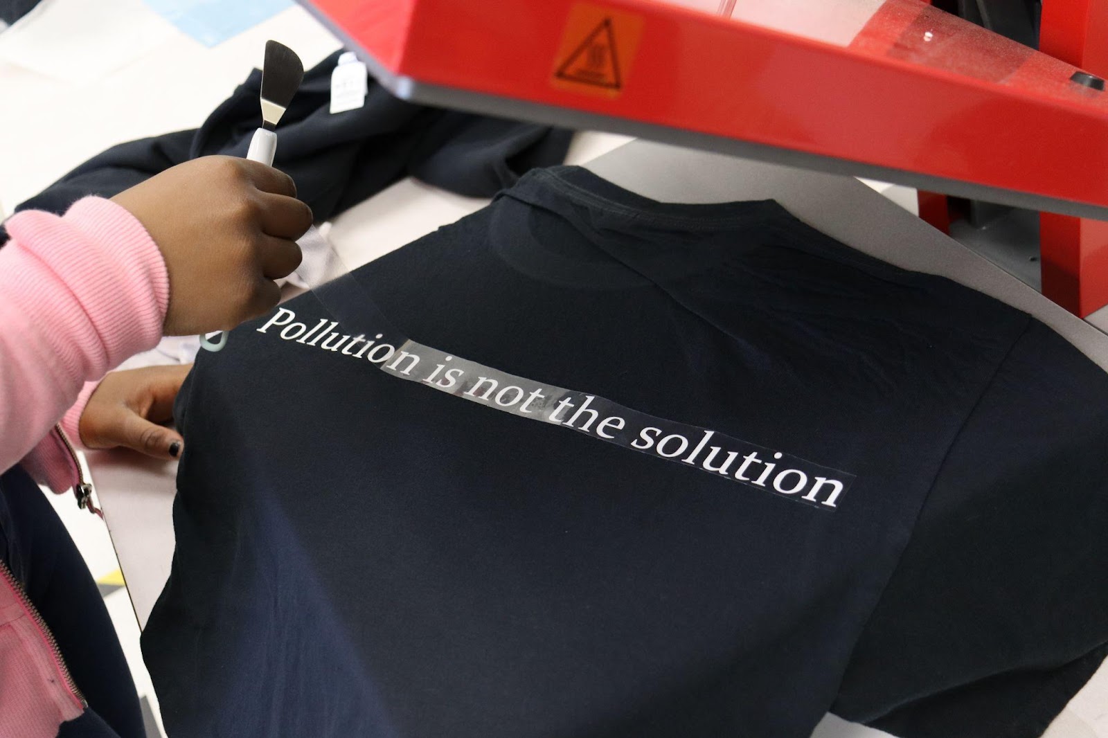 T-Shirt printed with "Pollution is not the solution" writing.
