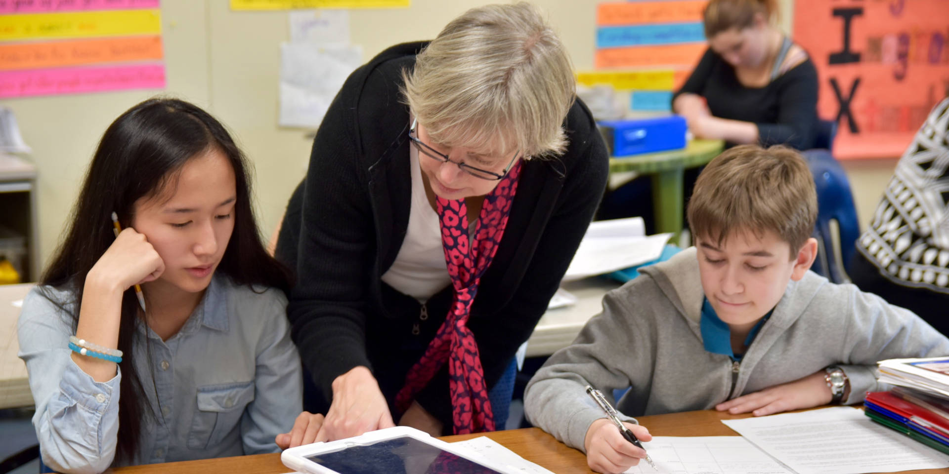 Teacher working with two students