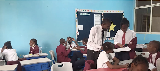 Teacher and students in a classroom.