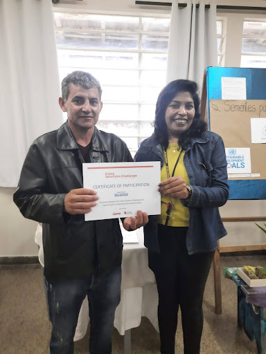 Man and woman standing side by side holding a Ciena Solutions Challenge Certificate of Participation.
