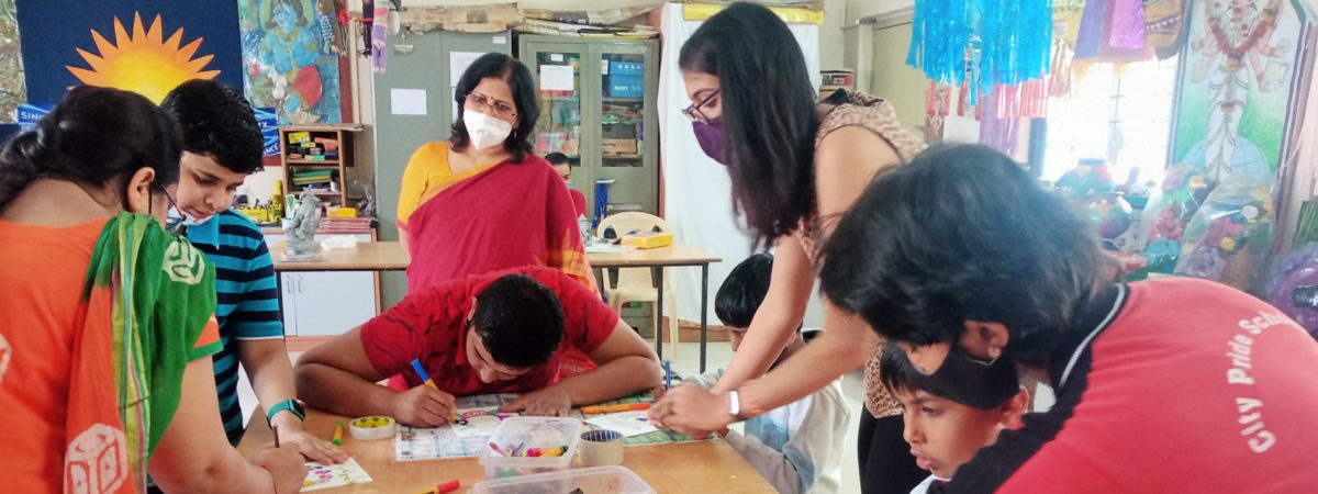 Students in India work on an art project using markers
