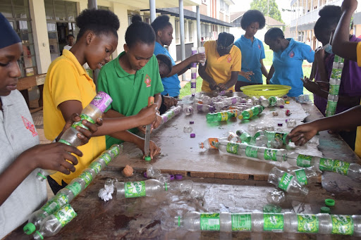 A group of students work with plastic bottles 