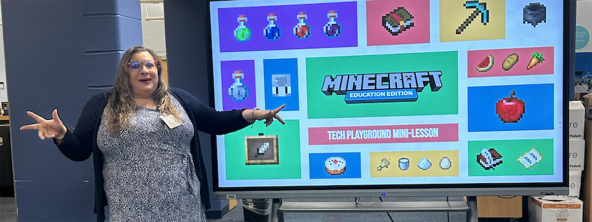Educator in front of class demonstrates Minecraft Education Edition