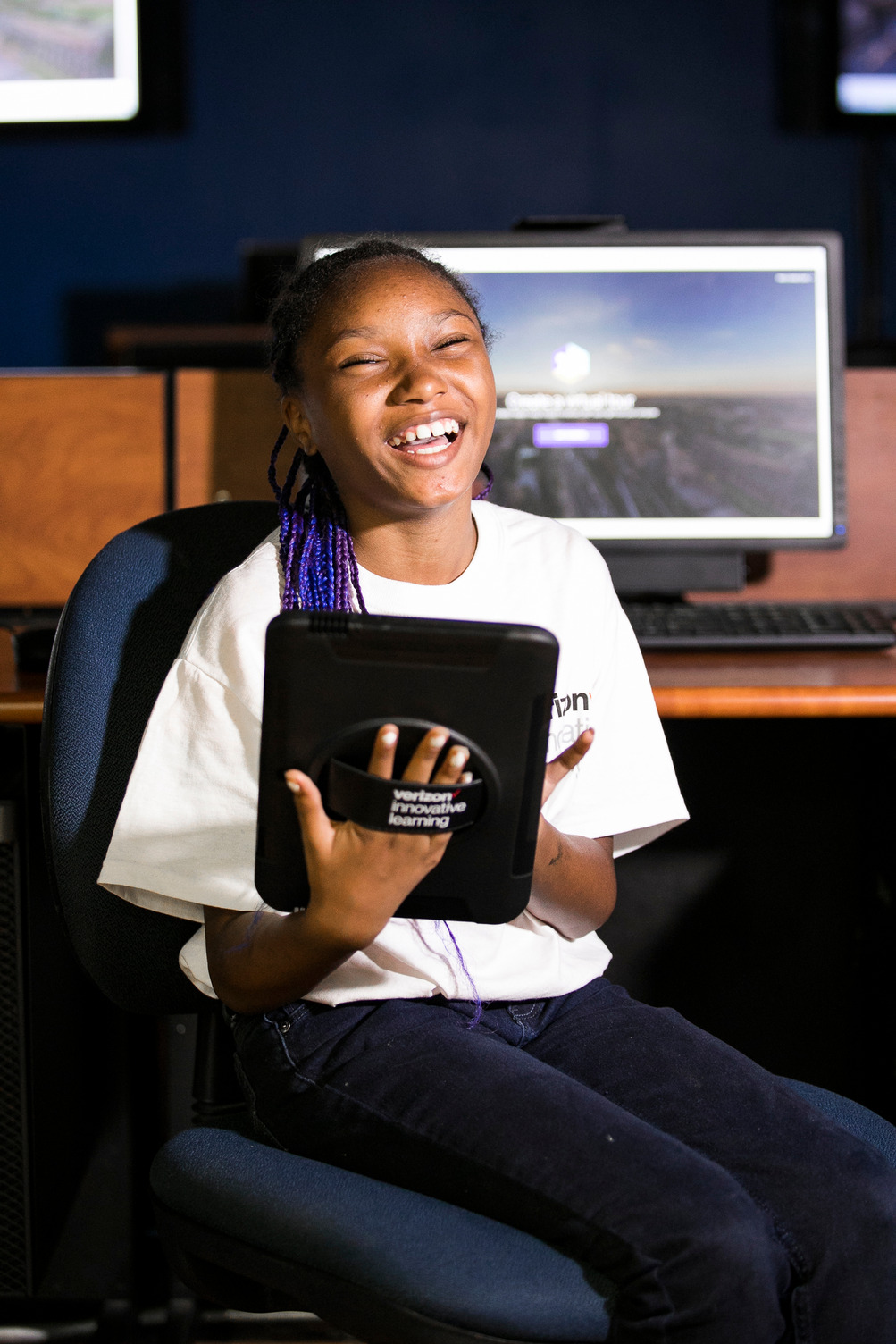 Girl smiling holding tablet