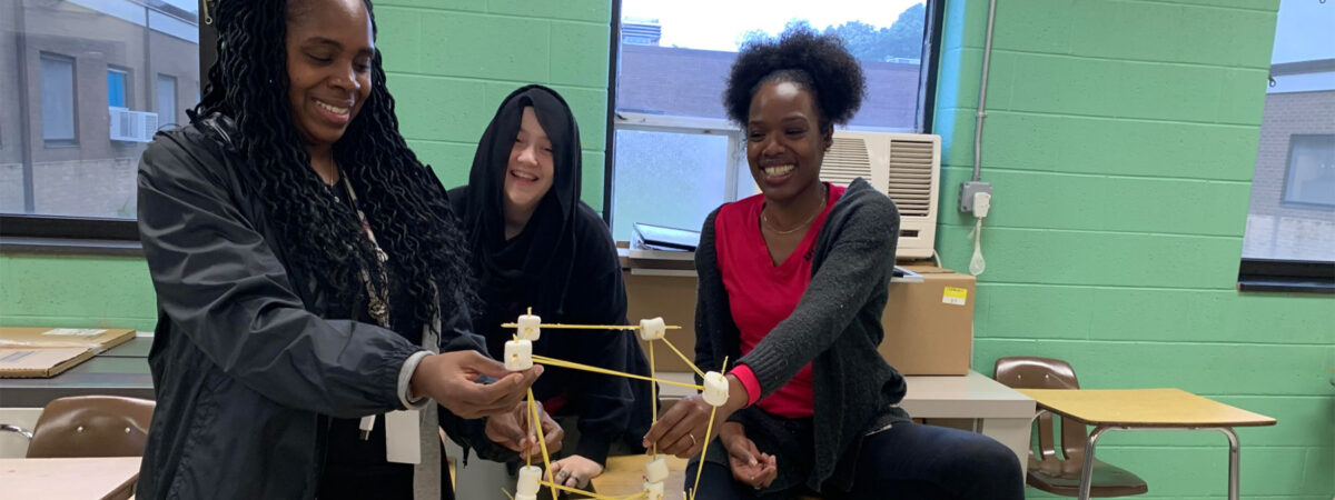 Bristol Township School District student and mentor participate in a marshmallow challenge as part of the mentorship program.