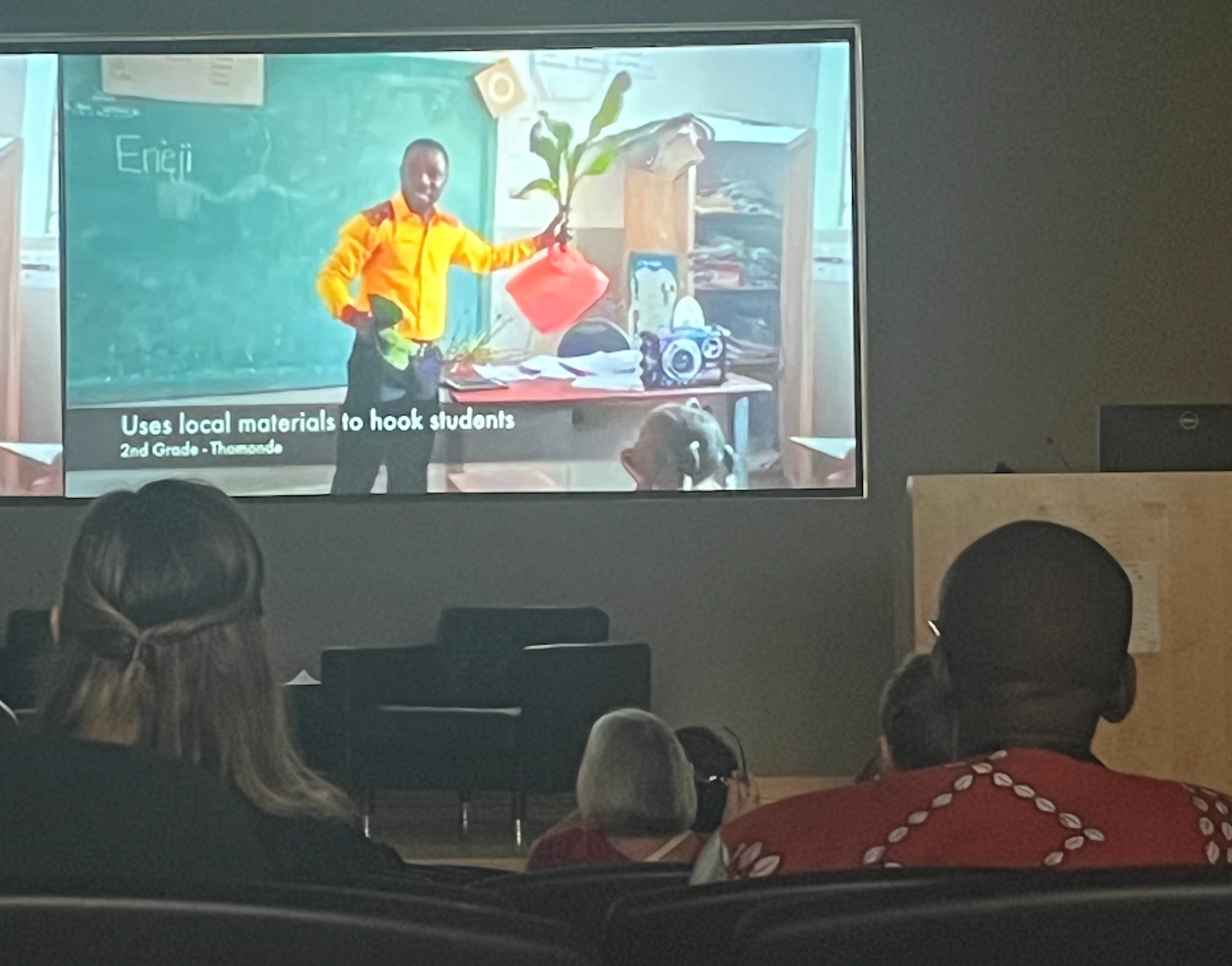 Symposium participants watch a video on the use of local materials in the interactive science learning program that Digital Promise and Blue Butterfly are implementing in Haiti. 