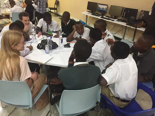 A group of students work together at a round table. 