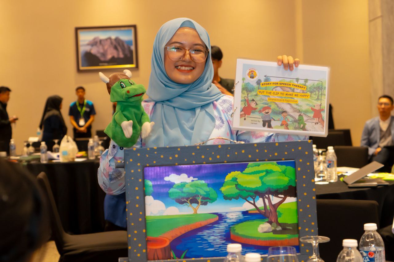 A student poses with a puppet, certificate, and a painting.