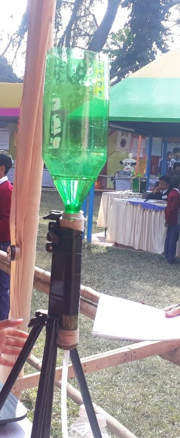 An upside down glass bottle mounted on a charcoal filter. 