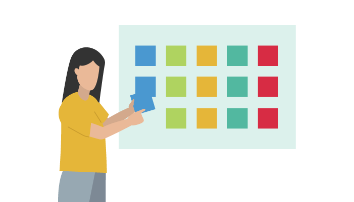 woman at board with rows of sticky notes