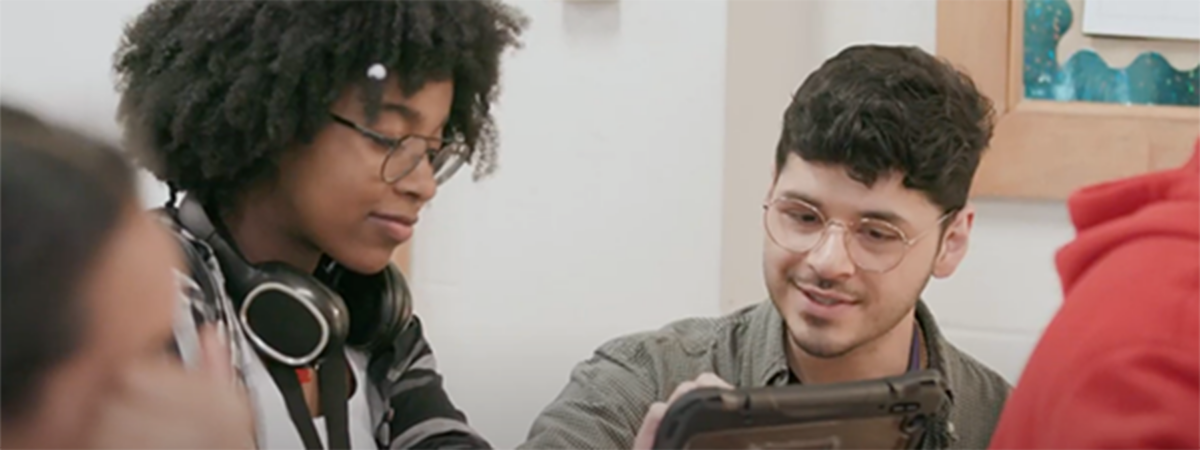 teacher and student looking at tablet