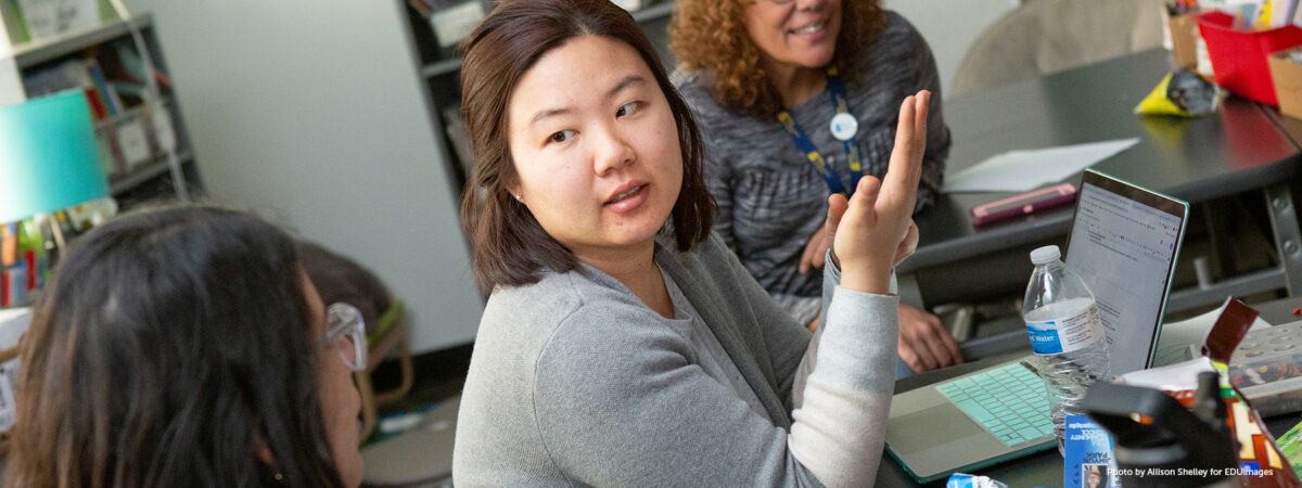 A kindergarten teacher shares her lesson ideas during a team planning session.