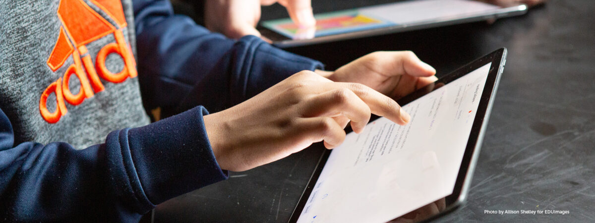 Middle school students complete classwork on tablet computers.