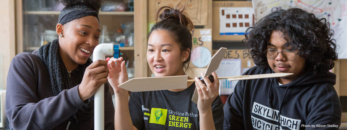 Students assemble a model wind turbine they constructed.