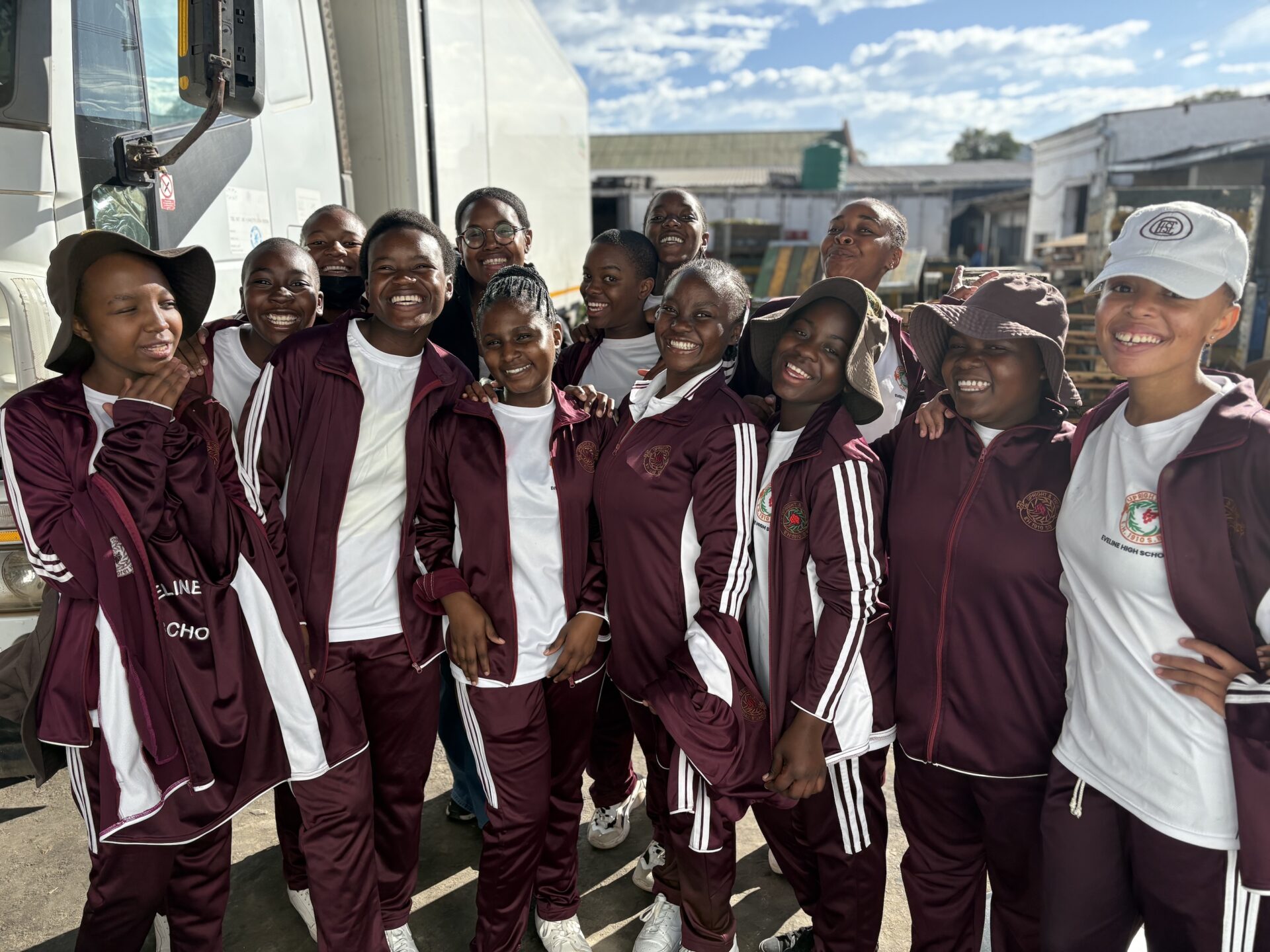 Students pose for a photo at the produce market.