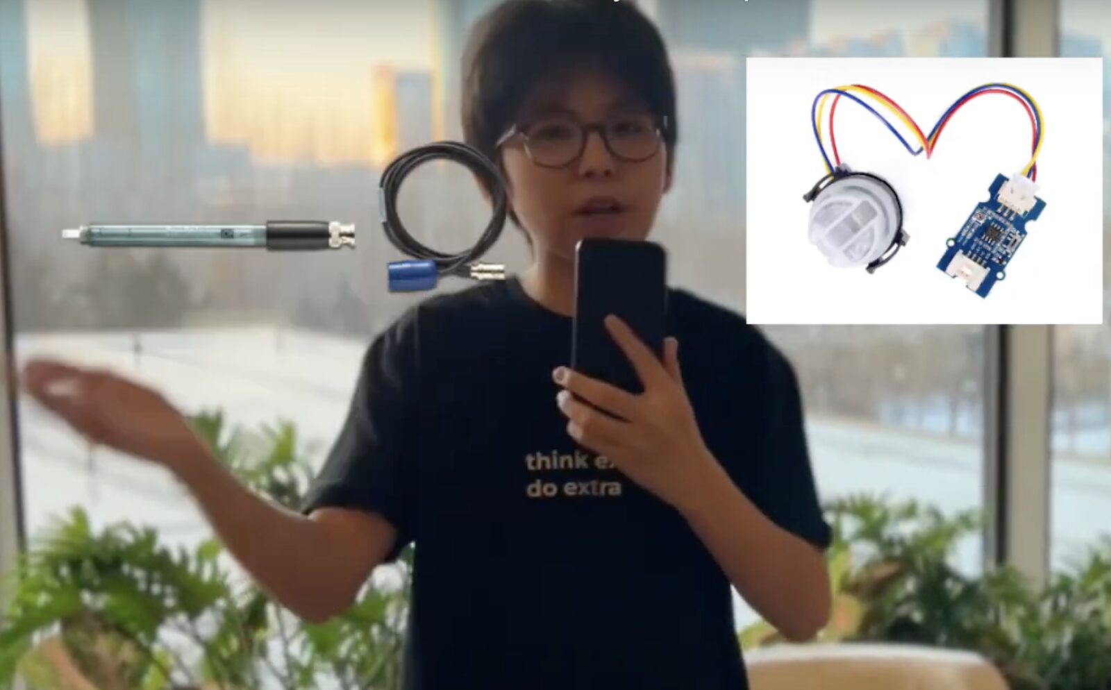 Student holding a mobile device while motioning towards graphics of a pen, cable, and sensor device.