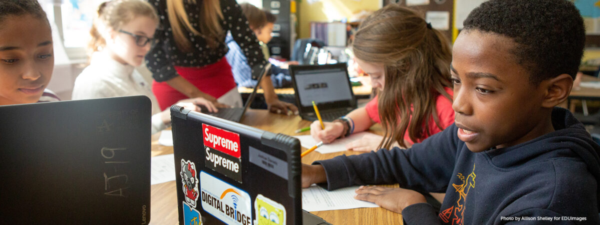 Students at Sutton Middle School use online research to answer questions during a lesson in history class.