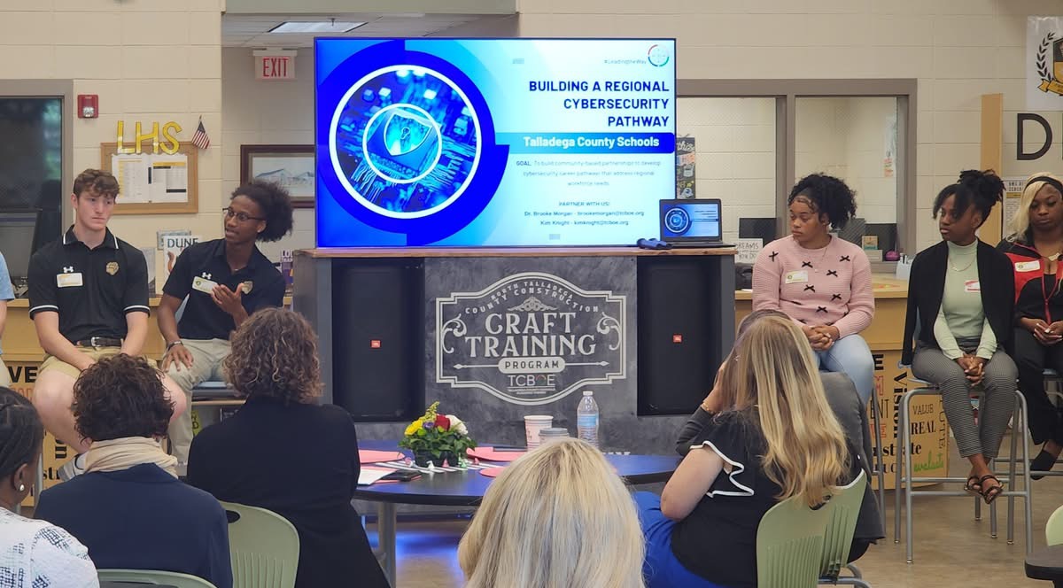 Seth Walker (second from left) speaking during a 2023 League of Innovative Schools convening hosted by Talladega County Schools in Alabama.