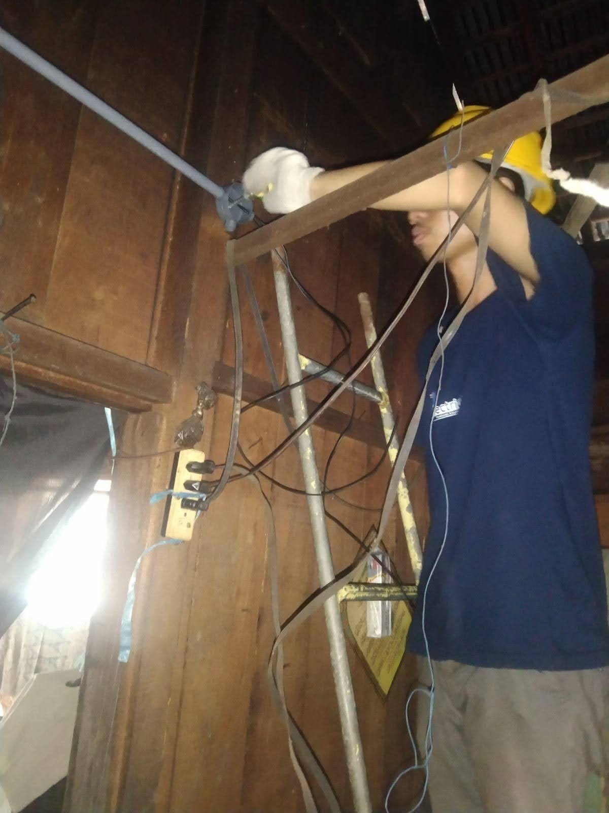 A student works on a repair in a home