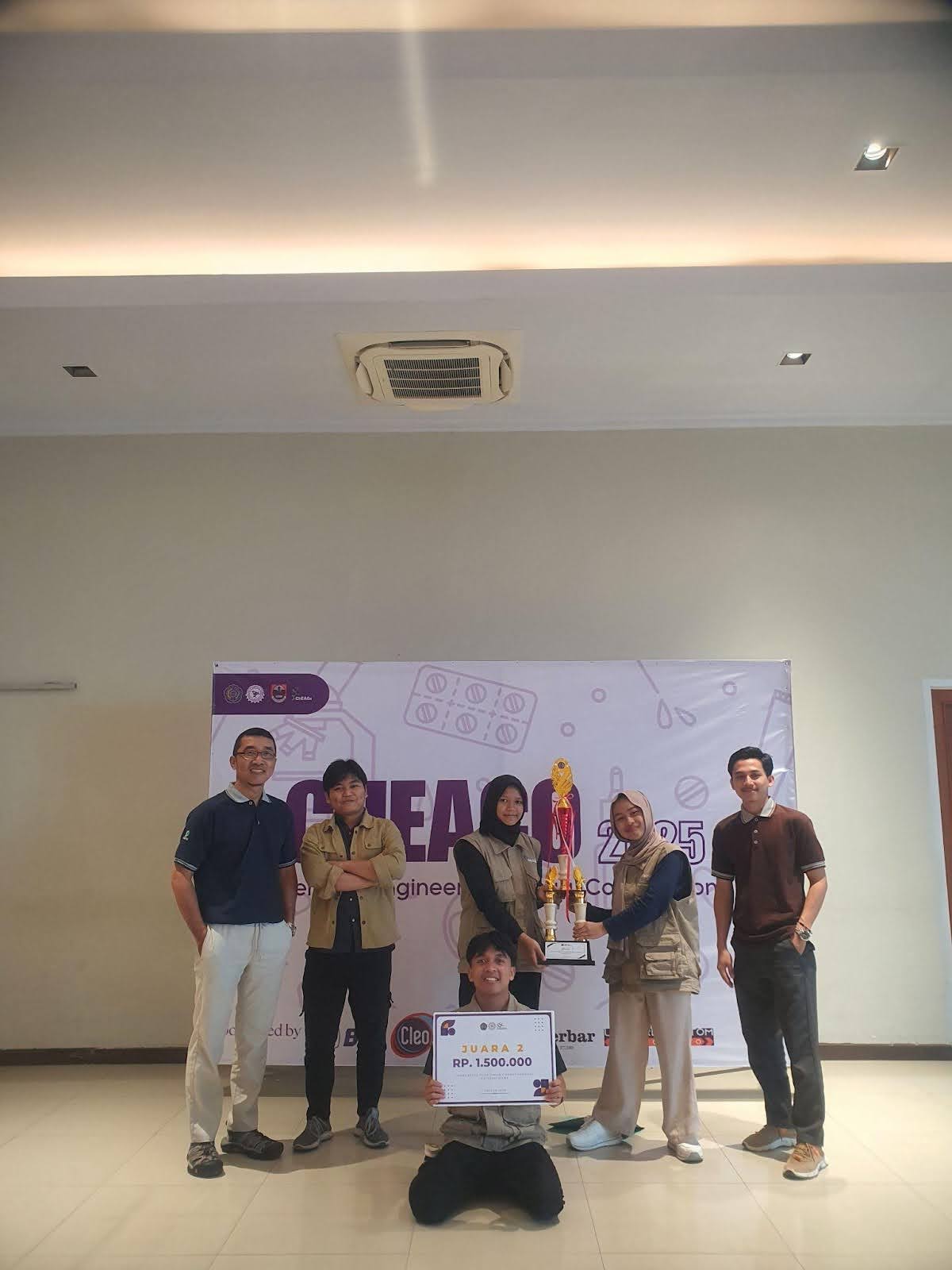 Students and teachers pose for a photo with a trophy