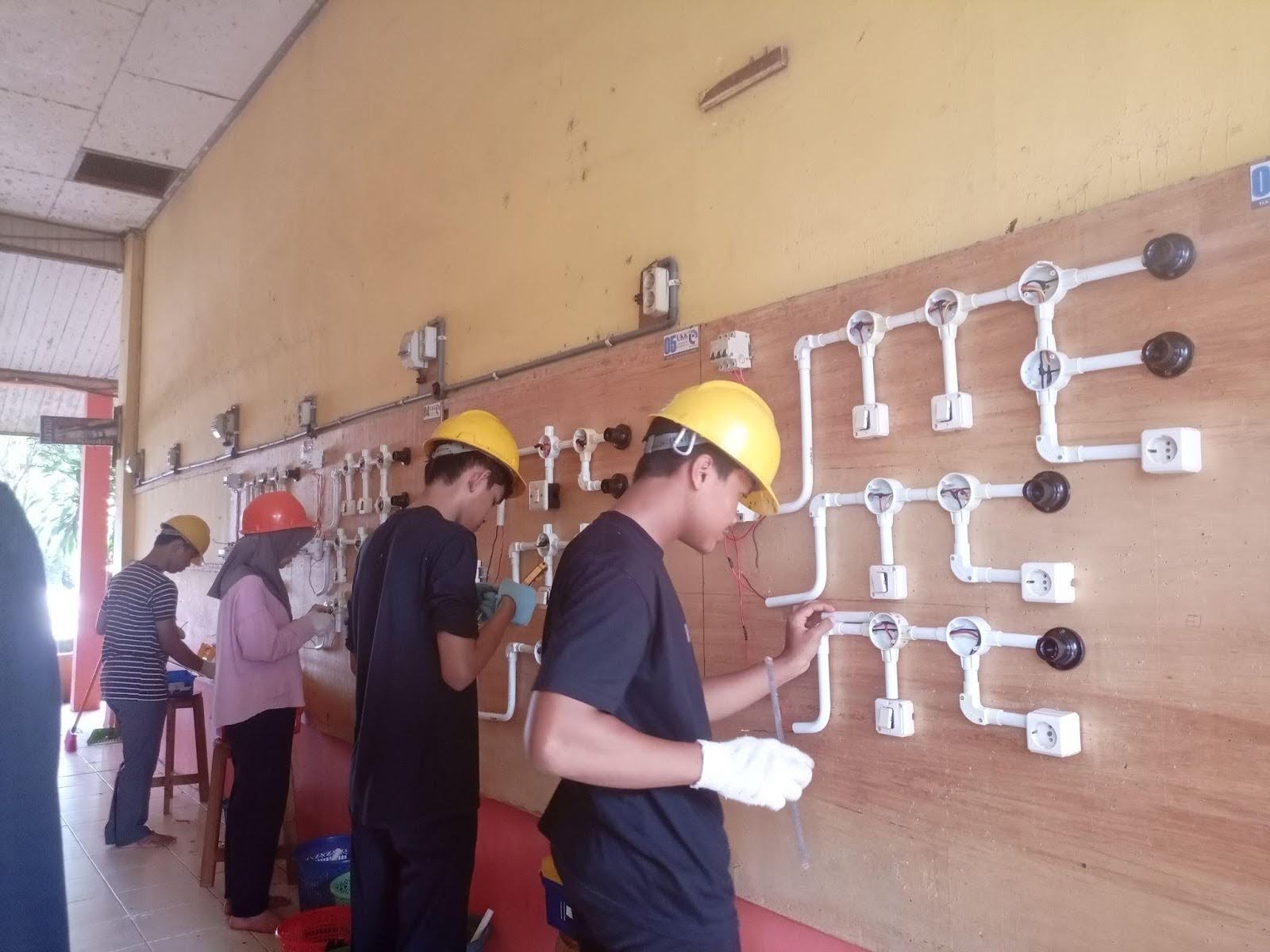 Students work on a practice electrical circuit