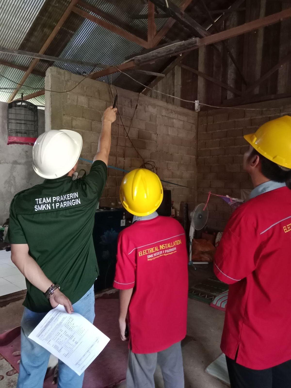 A teacher and two students work on a home repair