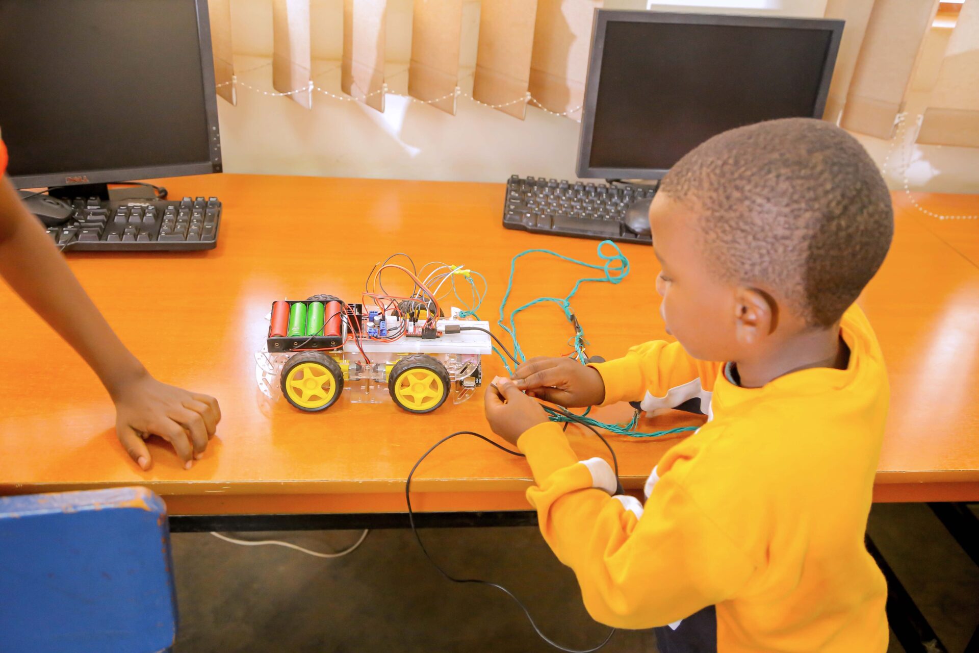 A boy handles a prototype of a robotic car 