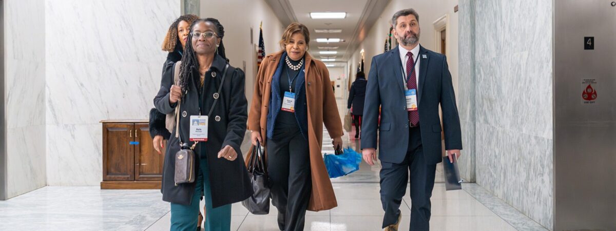 A group of district leaders walk down the hallway at Capitol Hill for the League's 2025 Policy to Action Summit in Washington, DC.