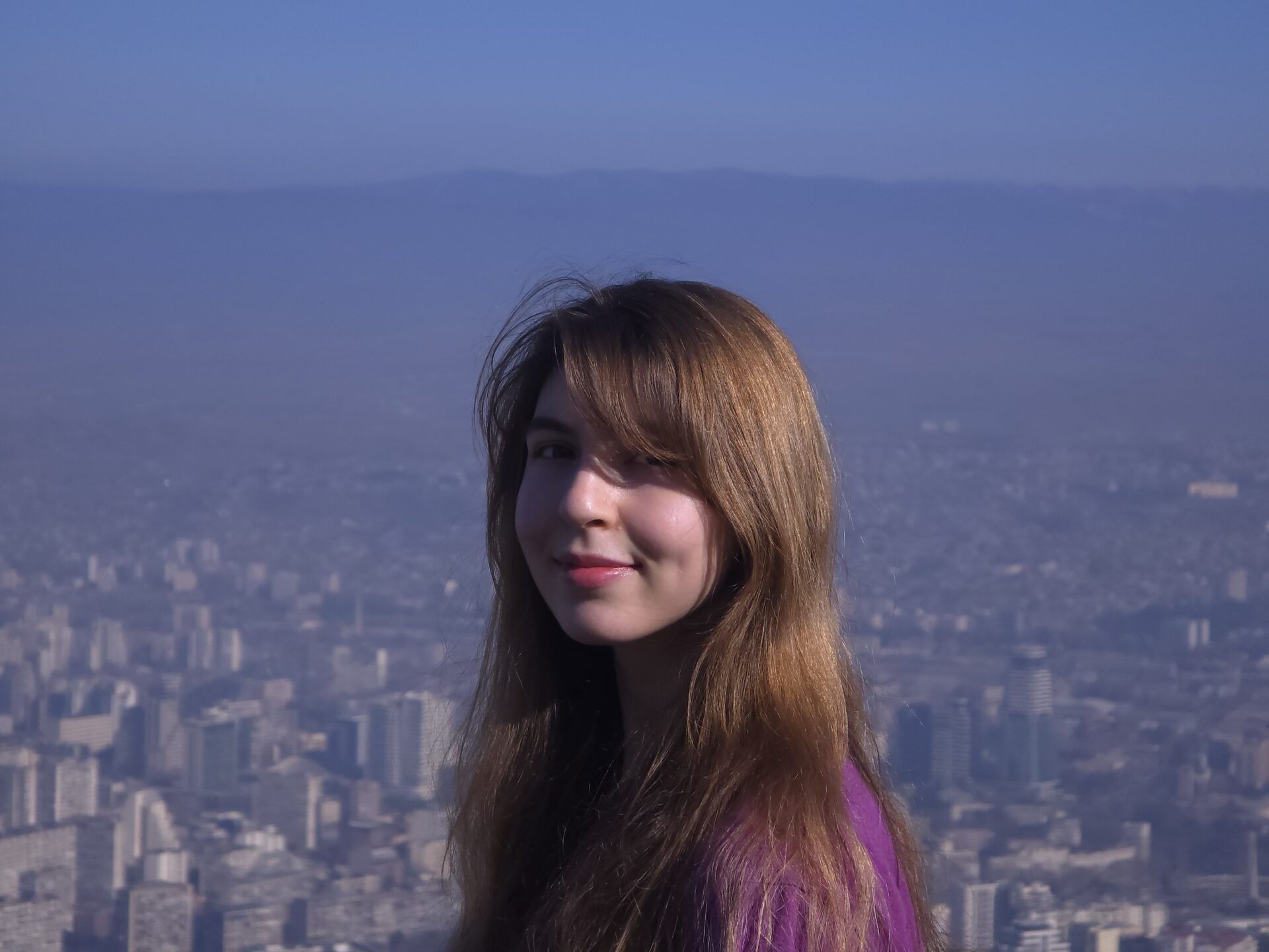A photo of Nino in front of a city skyline.