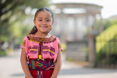 Portrait of a beautiful indigenous girl with a colorful dress from Quiché.
