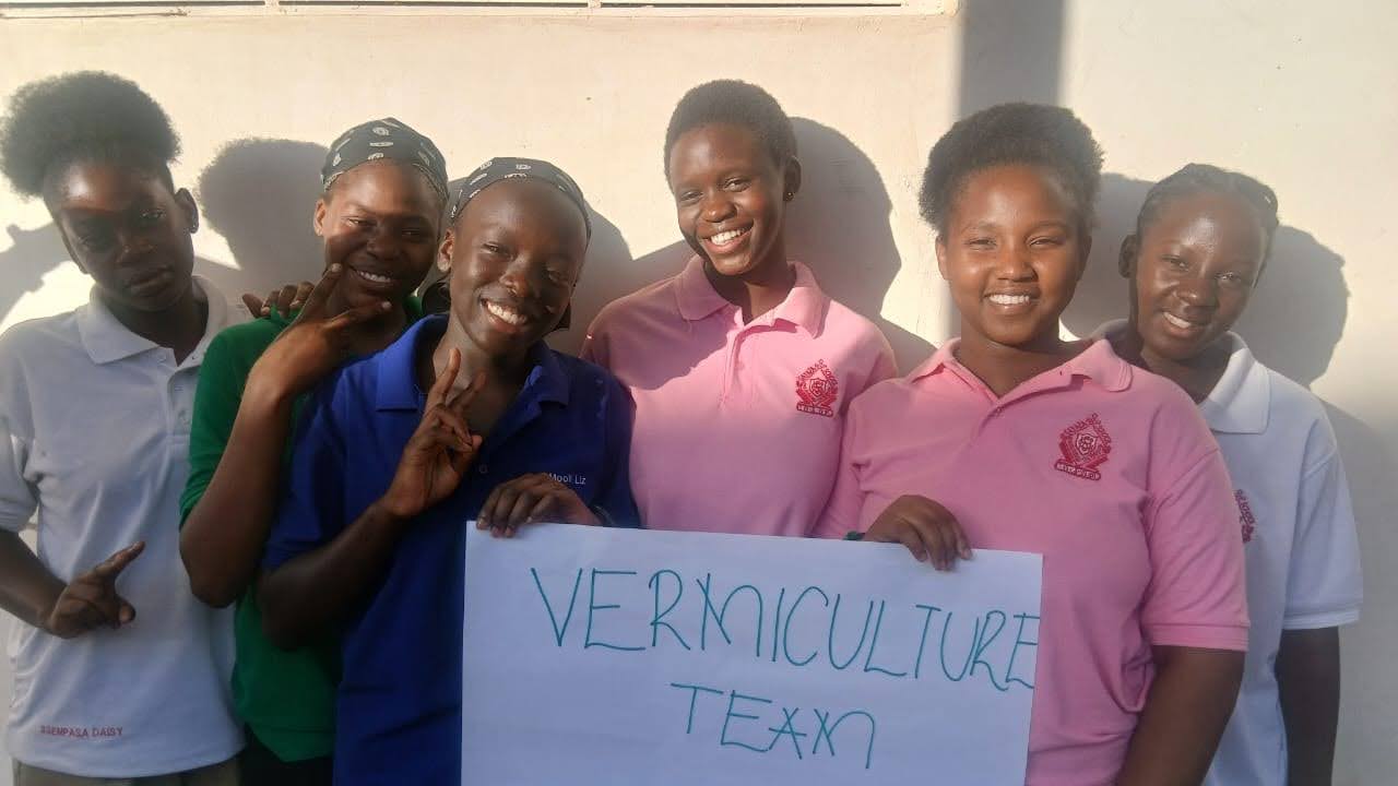 Six students pose for a photo with a poster that reads "vermiculture team."