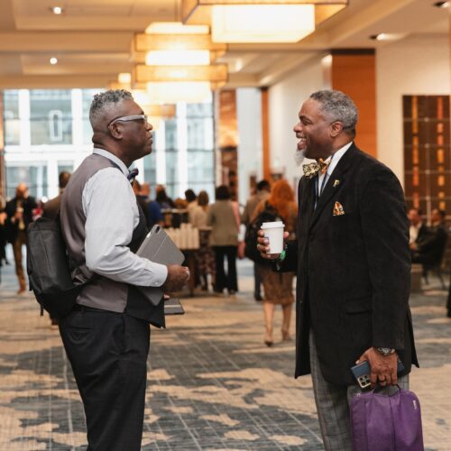 Two adults meet in a conference room